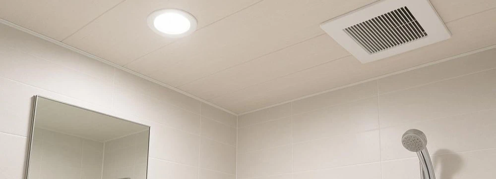 PVC ceiling sheet installed in a residential bathroom showing smooth white finish with recessed lighting trim and exhaust fan cutout demonstrating waterproof ceiling solution for high humidity environments PVC ceiling sheet installed in a residential bathroom showing smooth white finish with recessed lighting trim and exhaust fan cutout demonstrating waterproof ceiling solution for high humidity environments
